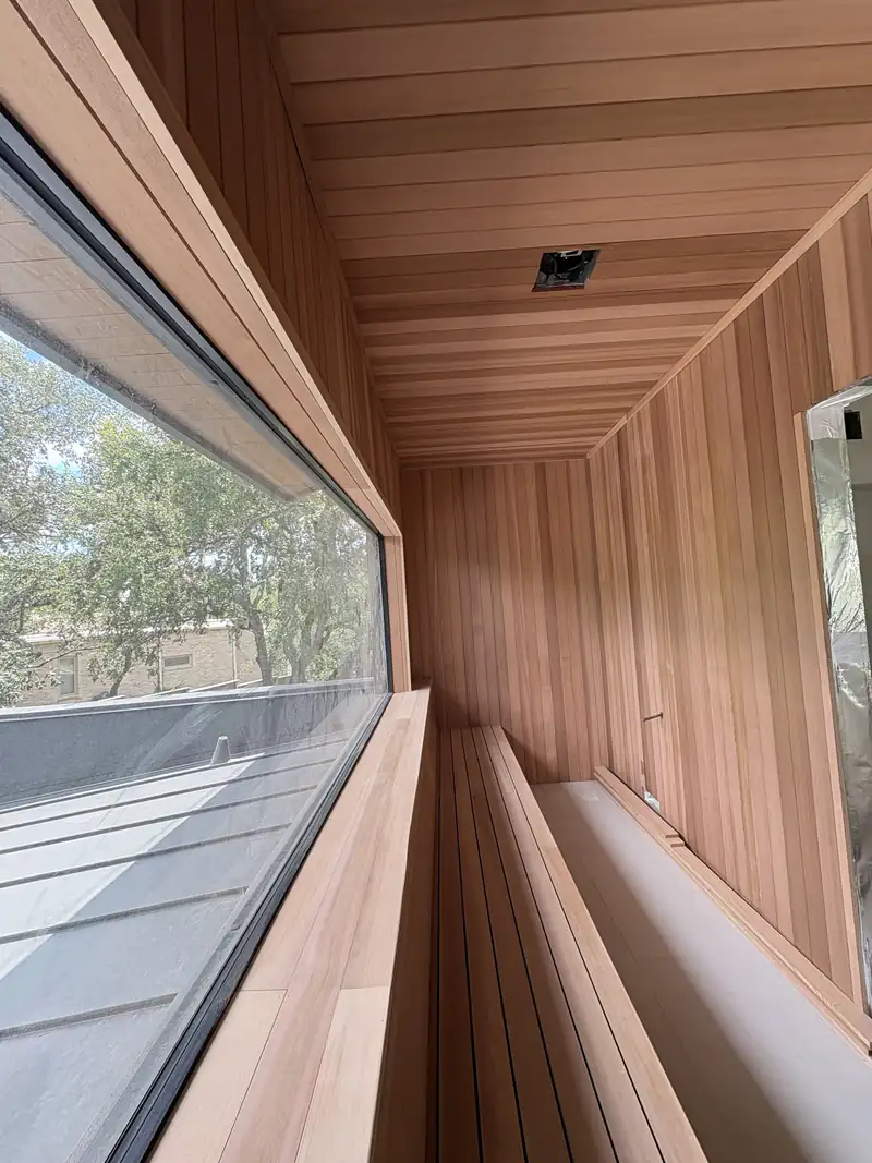 Cedar sauna interior with tongue and groove walls and a hand built bench