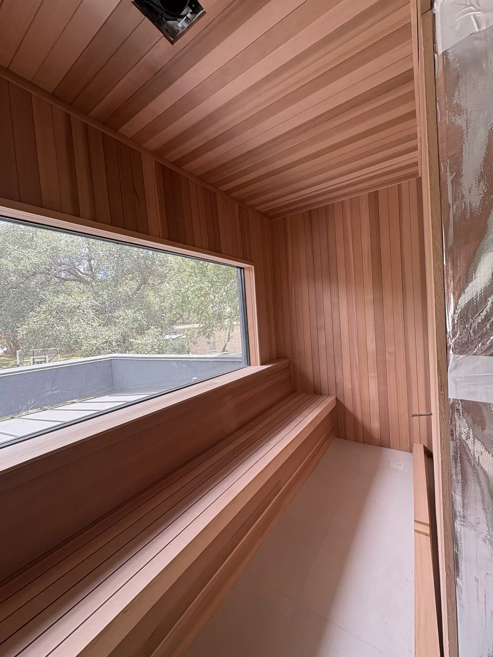 Cedar sauna bench and tongue and groove lining with warm light