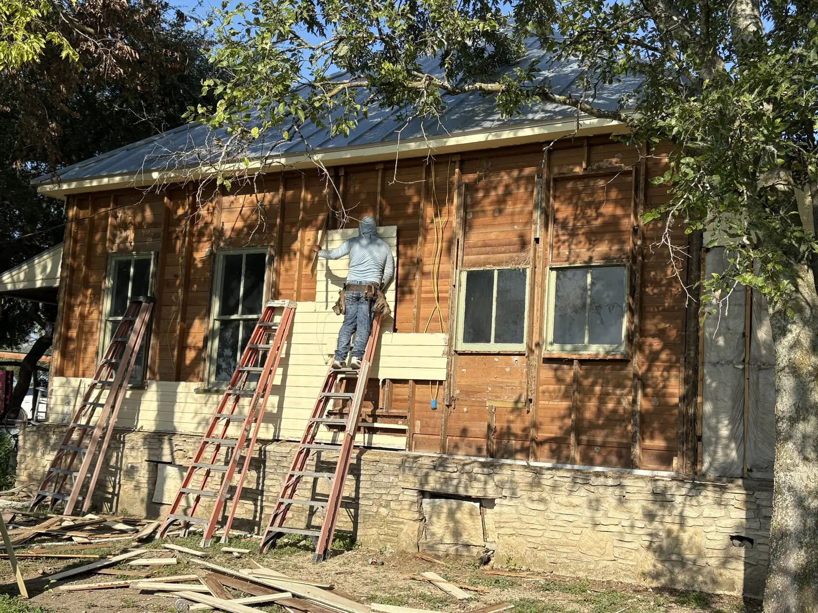 Farmhouse stripped back to sheathing and supported on shoring