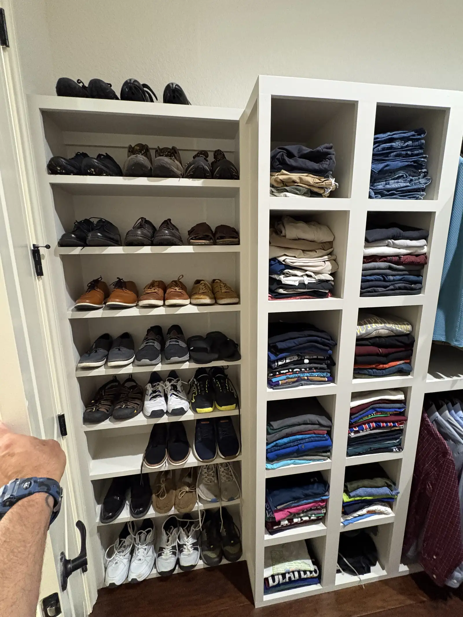 Custom closet with shoe shelving and full hanging sections in use