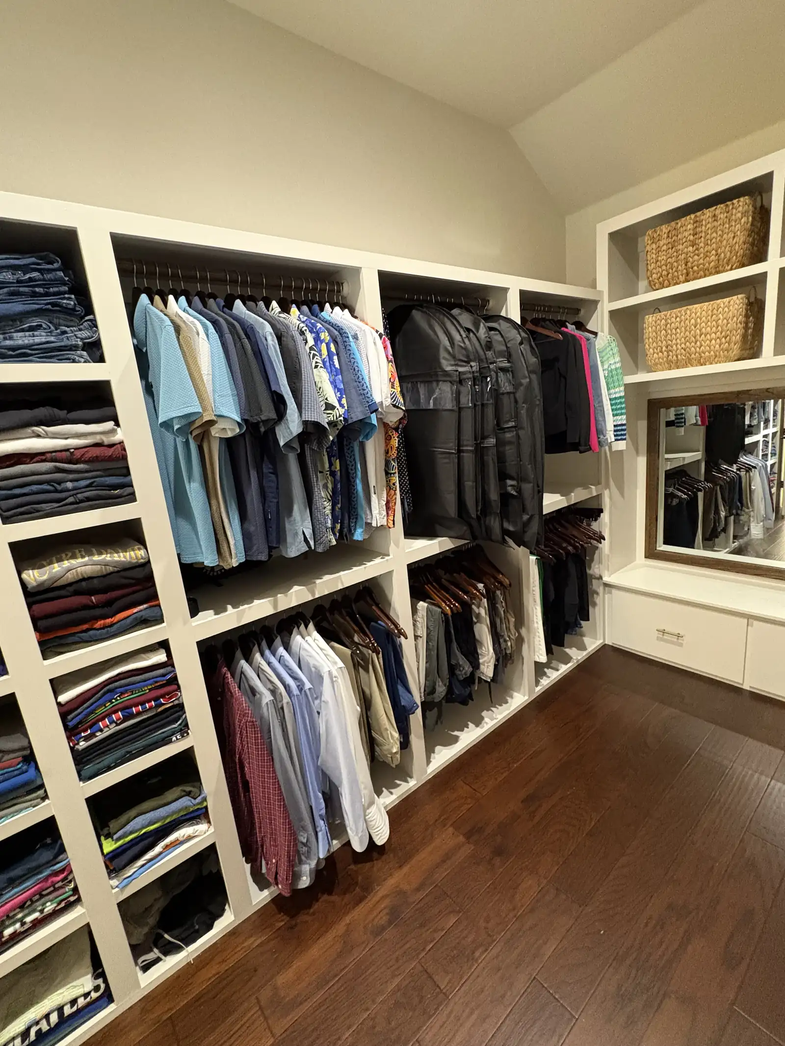 Walk in closet with clothes hanging and shelving fully in use