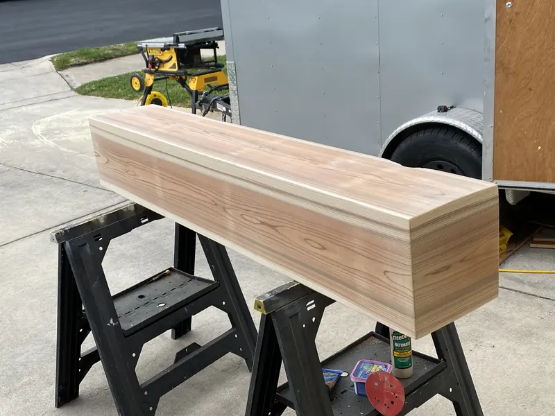 Cedar mantel clamped on sawhorses in the shop during construction