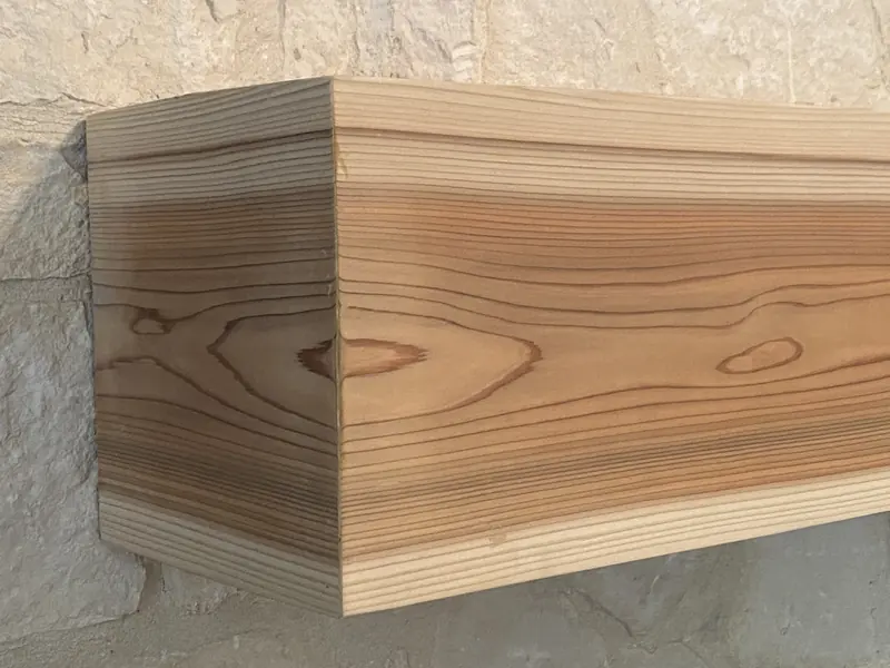 Close up of a mitred corner on a cedar fireplace mantel