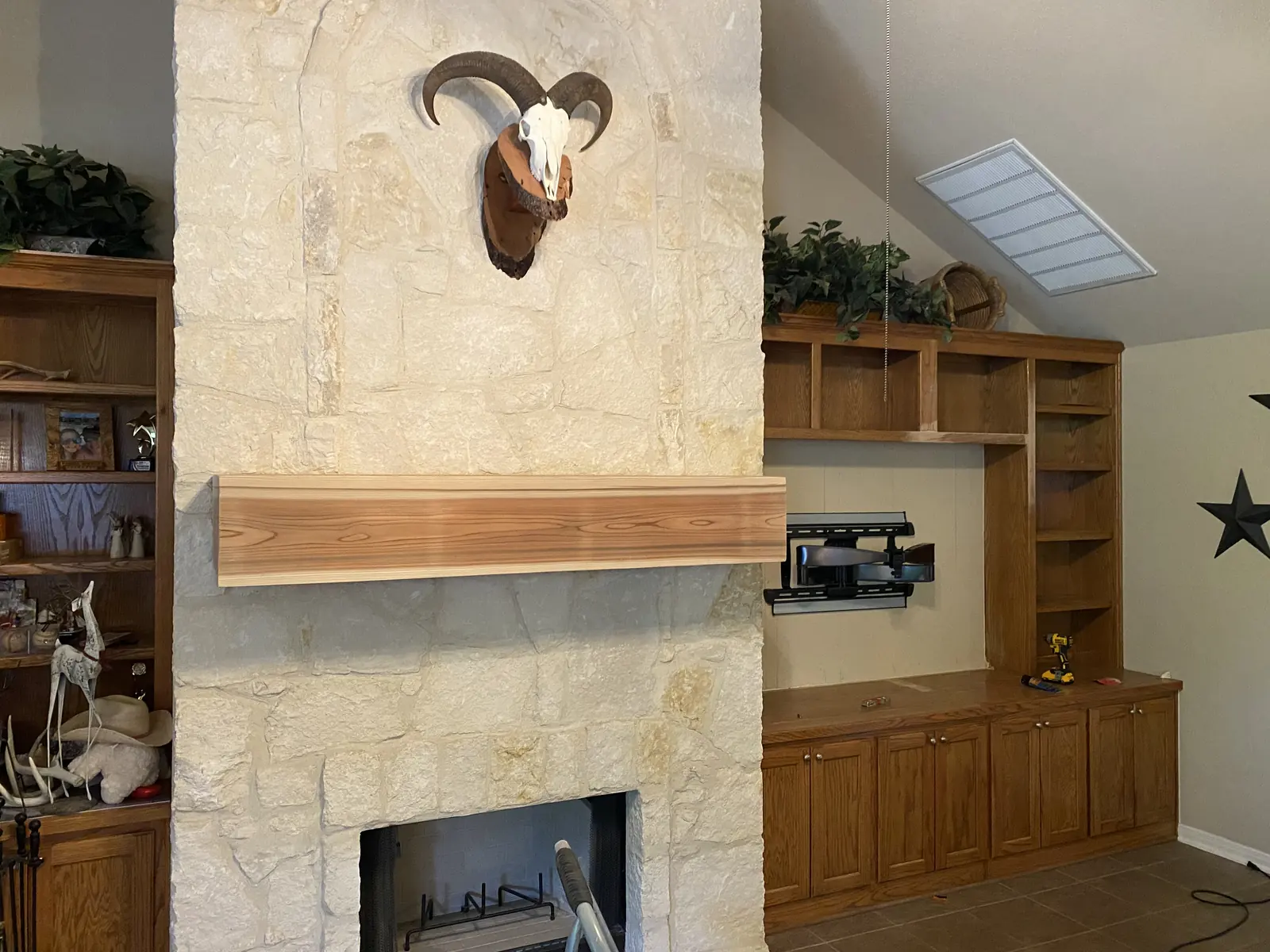 Heavy timber mantel installed on a stone fireplace