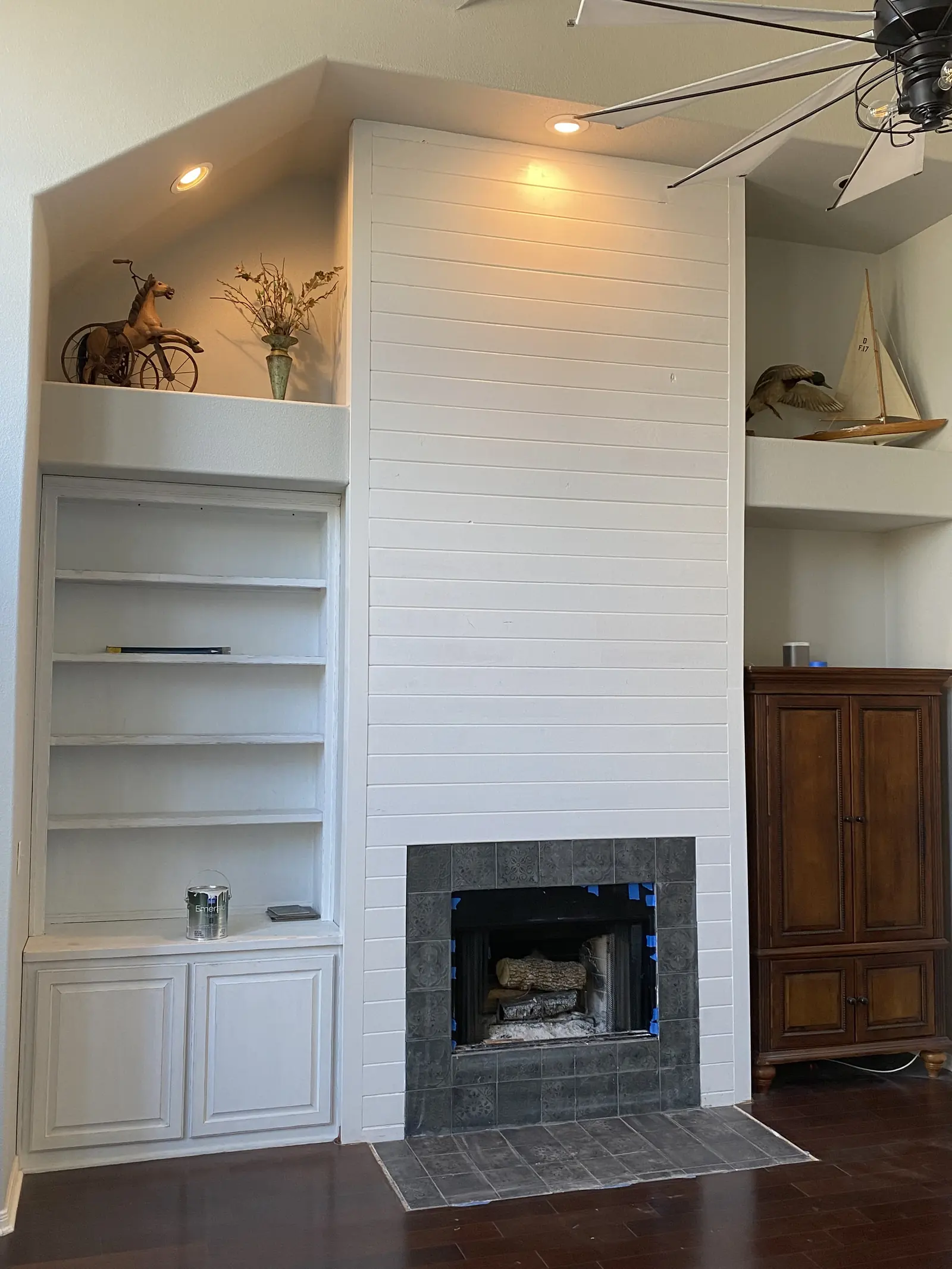 Rustic reclaimed beam mantel on a shiplap wall