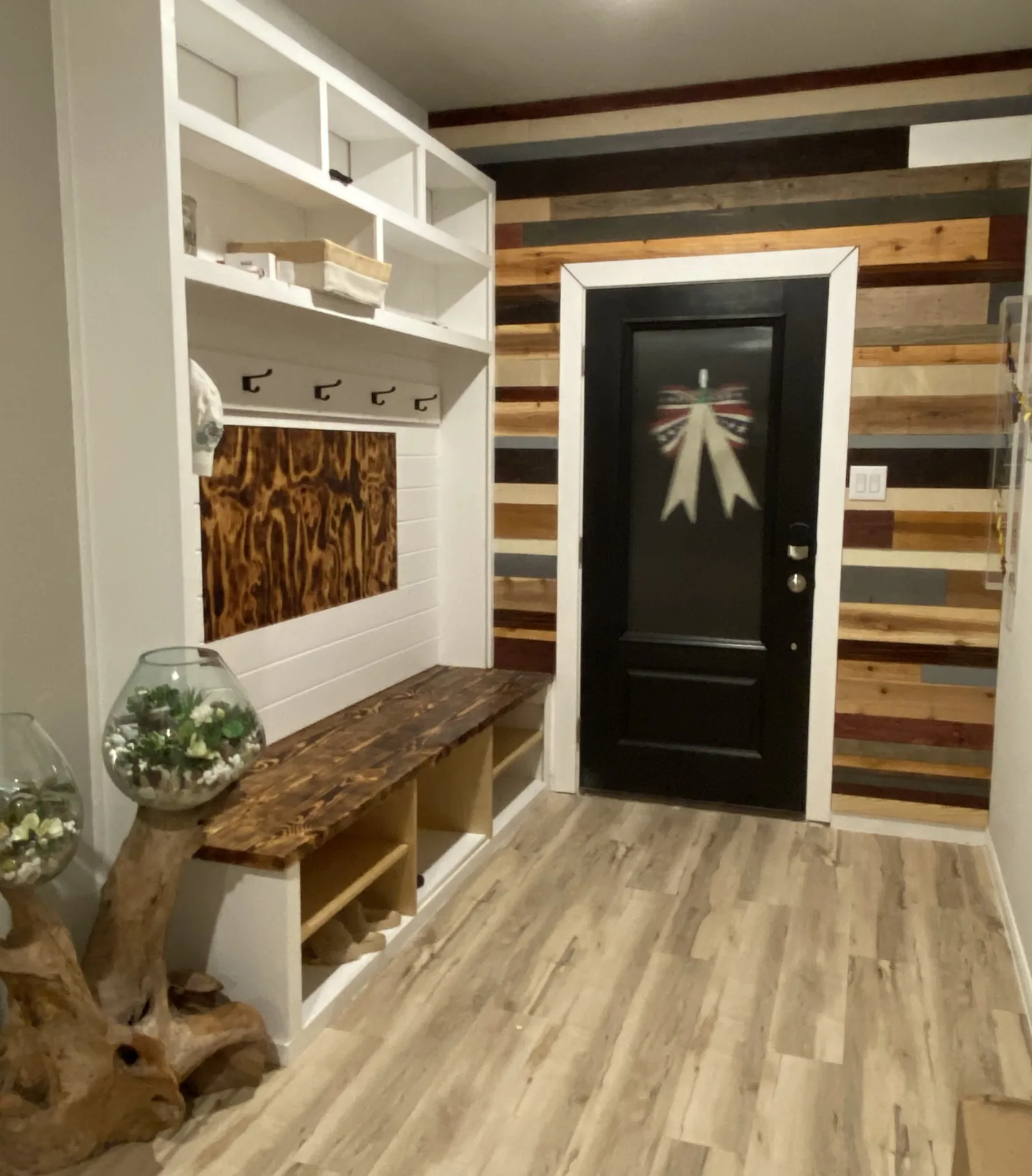 Mudroom with a live edge wood bench against a reclaimed plank wall