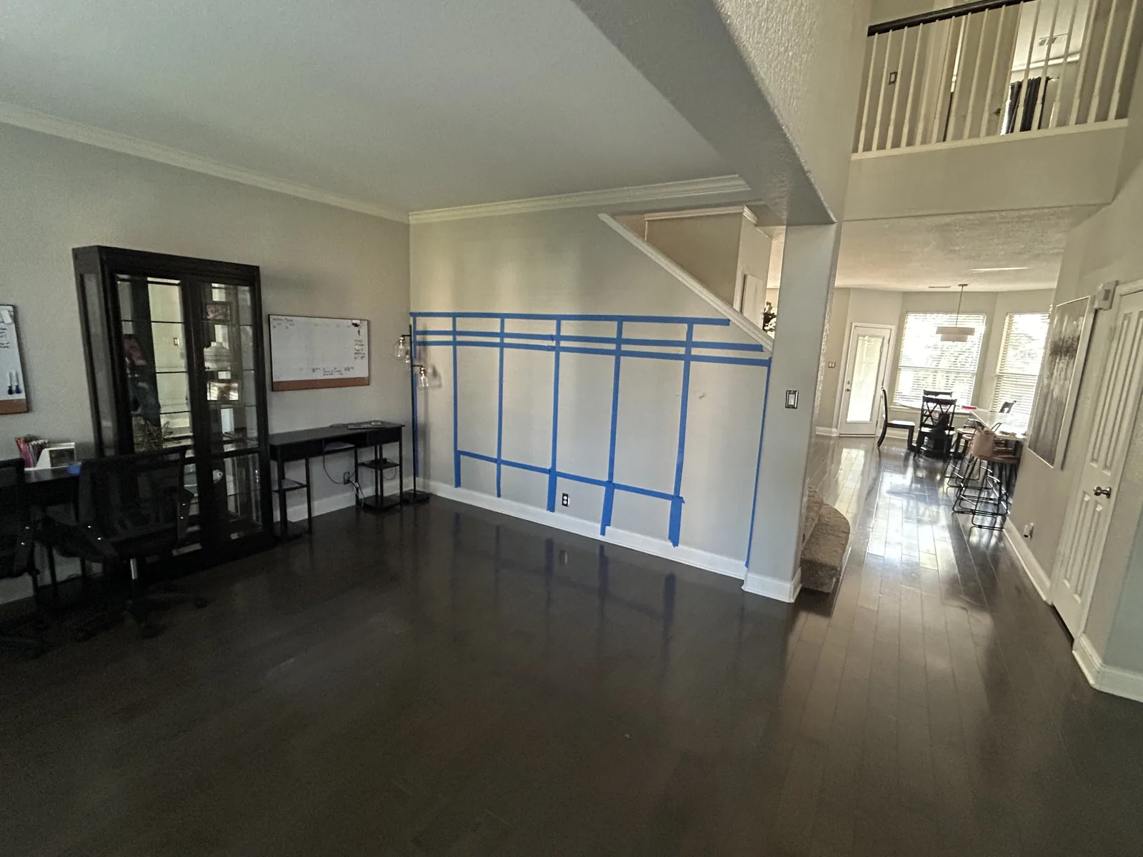 Empty hallway before mudroom lockers were built, layout marked out in tape