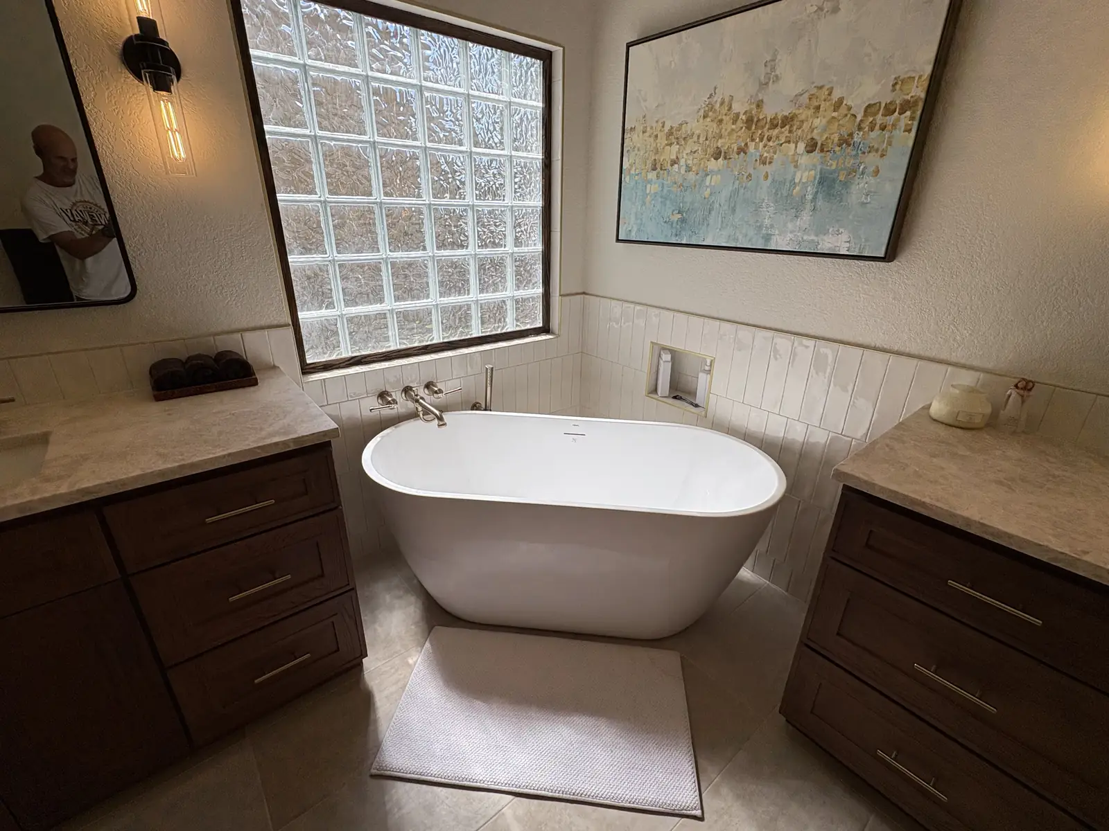 Primary suite bath with a freestanding tub and stacked tile