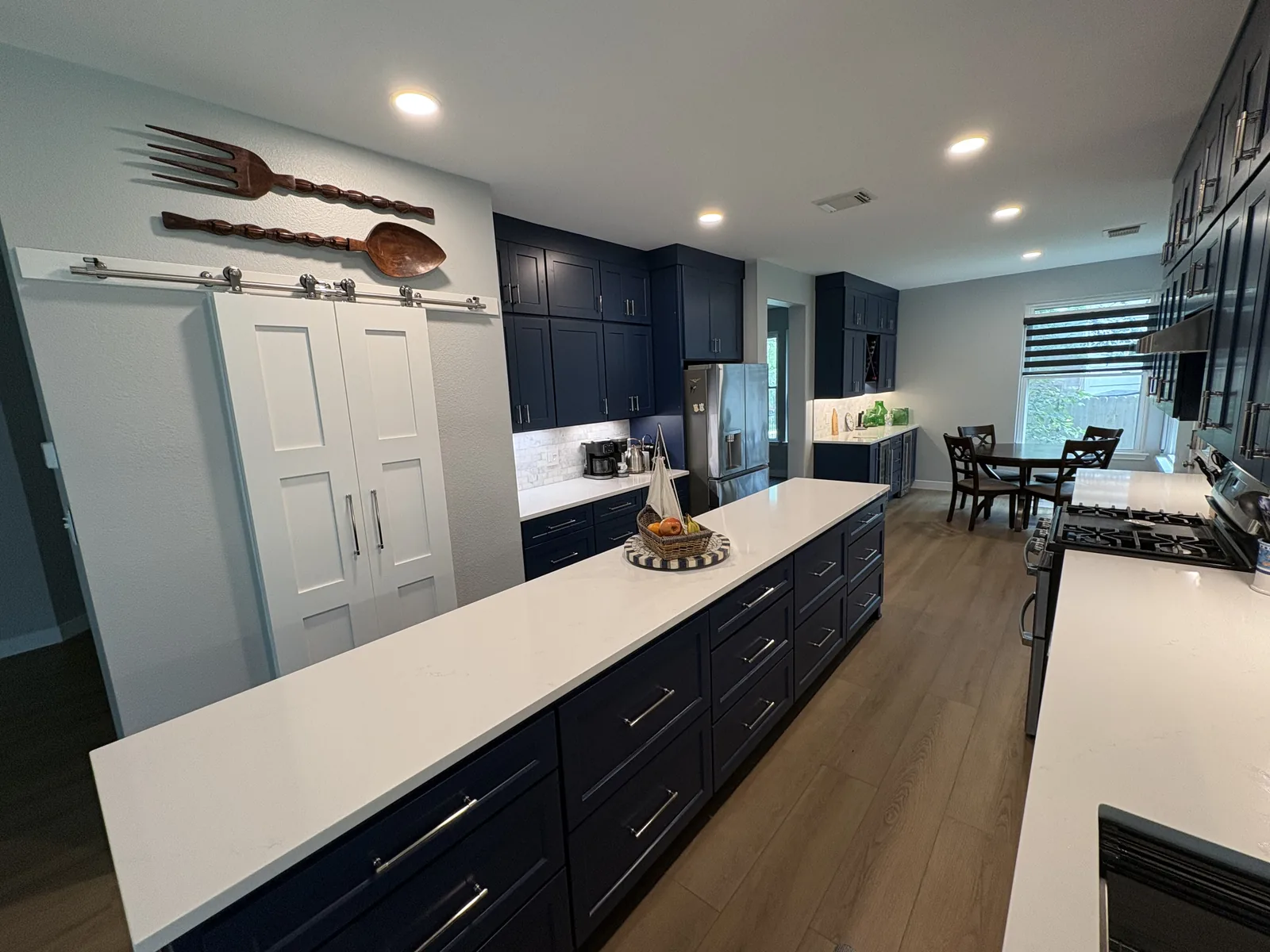 Stone Oak kitchen with navy cabinetry and a light stone counter
