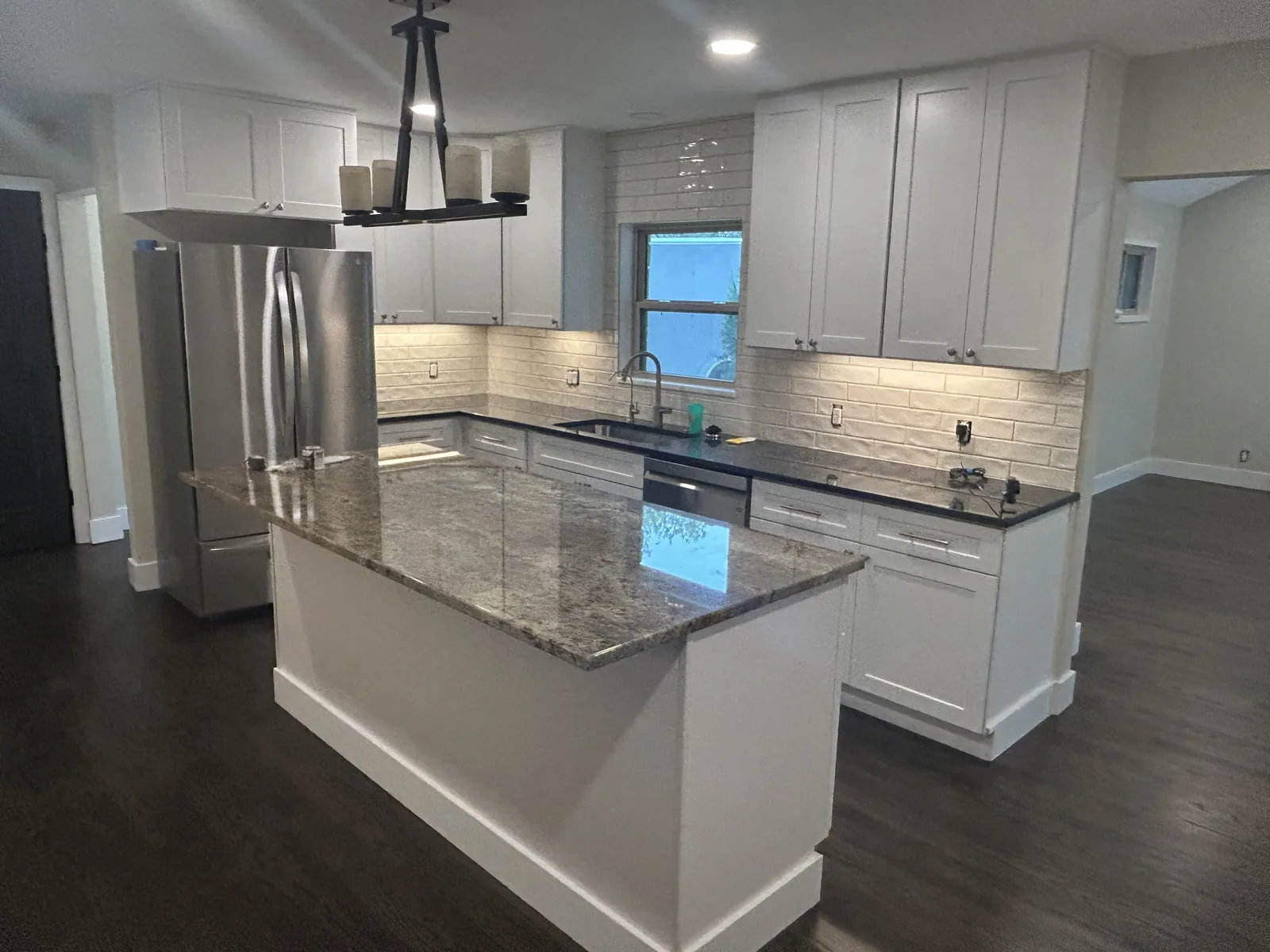 Terrell Hills kitchen with white shaker cabinets to the ceiling and a granite island