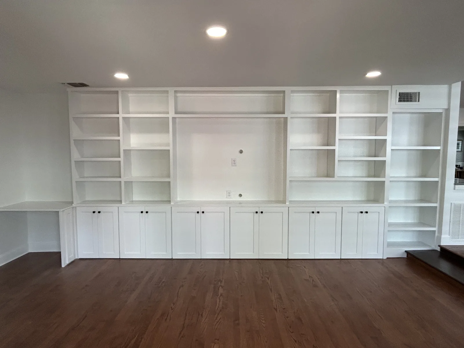 Full wall of built in shelving and cabinetry in a Terrell Hills home