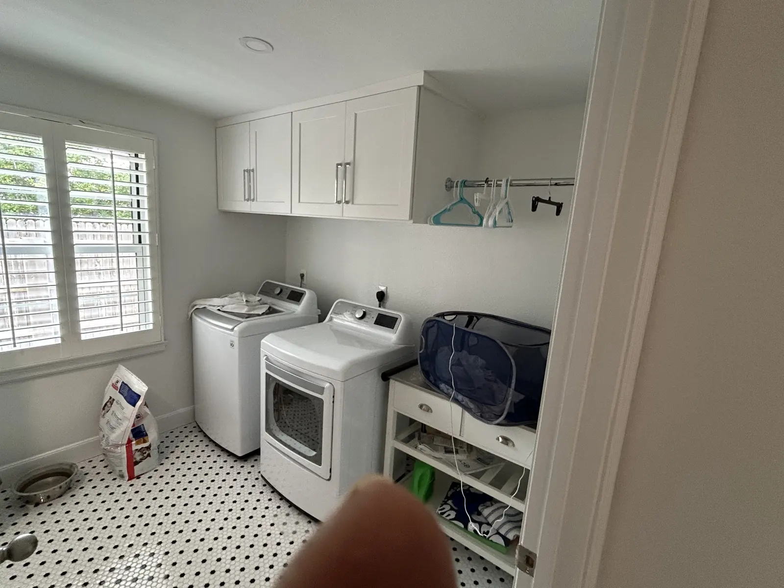 Laundry room with penny tile flooring and custom cabinetry