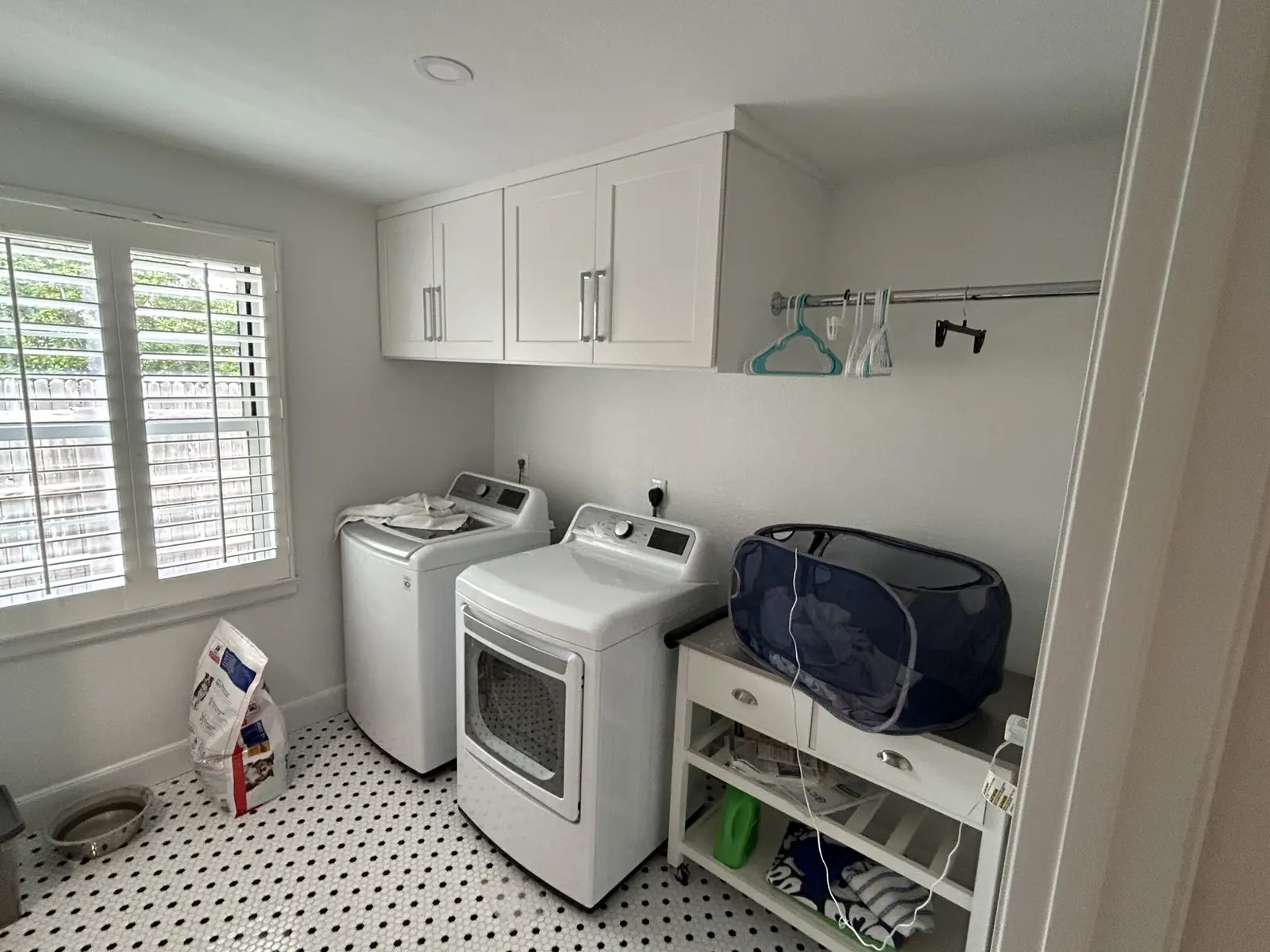 Powder room with wainscot panelling and penny tile flooring