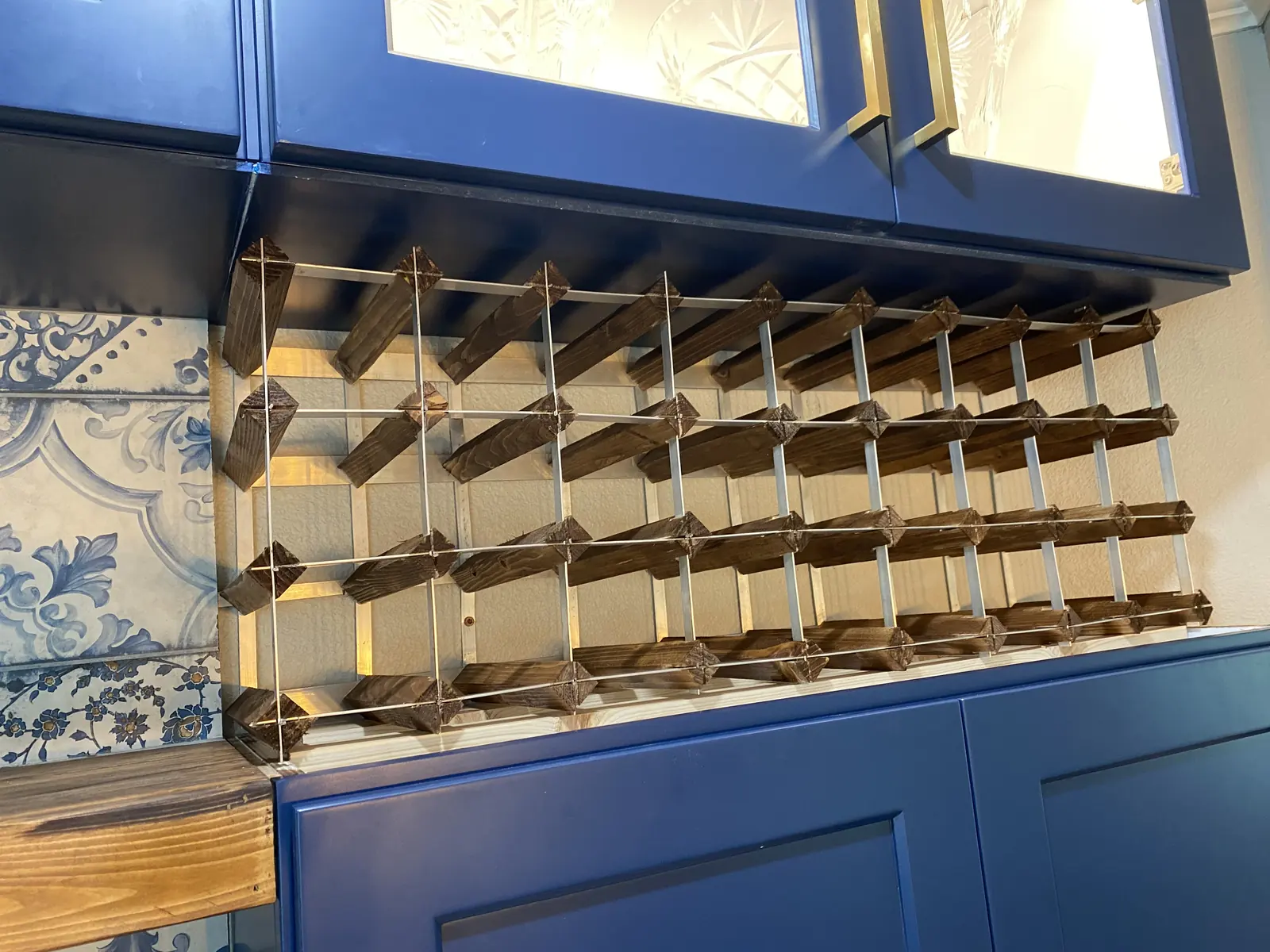Bar cabinetry with glass fronts and a built in wine refrigerator