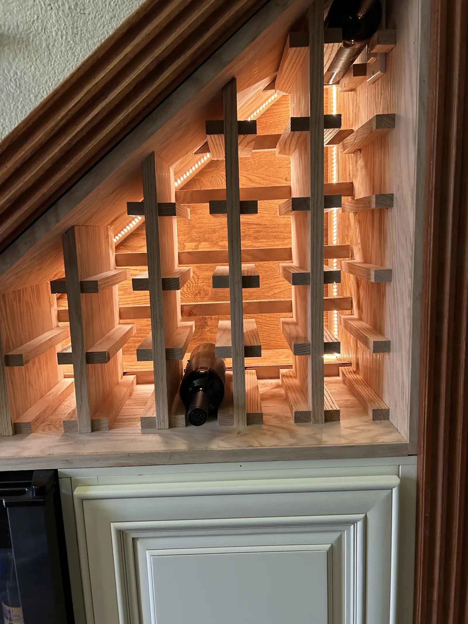 Wine storage built into the space beneath a staircase
